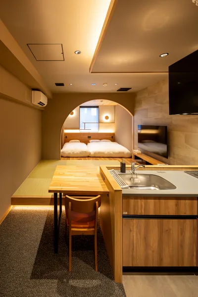 The arched bed area seen across the kitchen